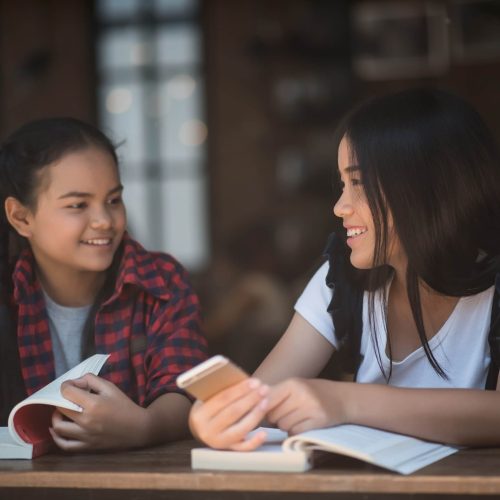 young-woman-using-looking-smartphone-with-feeling-happy